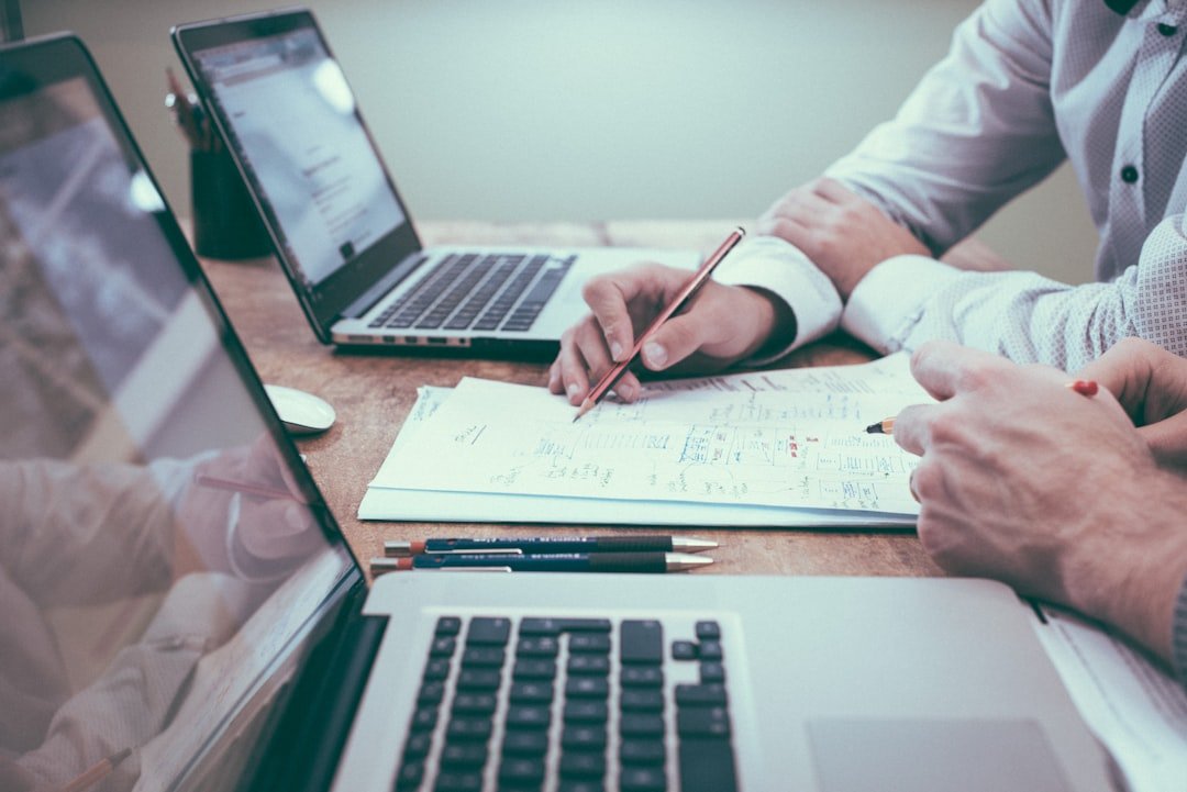Financial planning documents beside a laptop